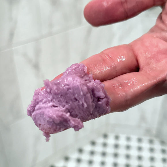 a close up of our cleansing scrub on fingers