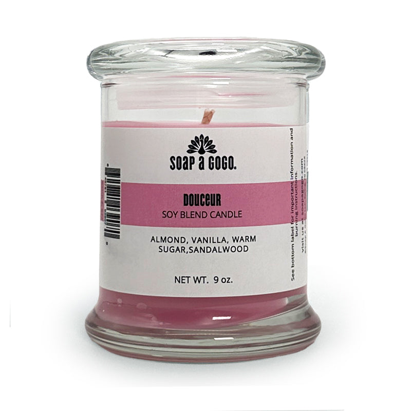 Candle in a glass jar with a label on a white background
