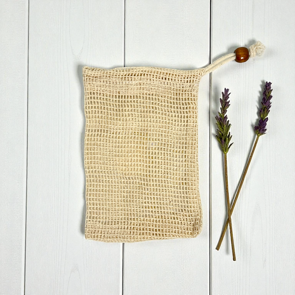 cotton soap saver pouch on a white wood background