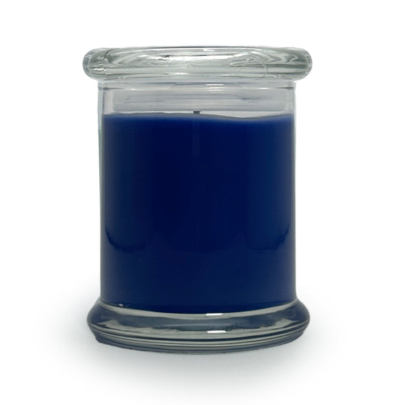 Blue candle in a clear glass jar on a white background