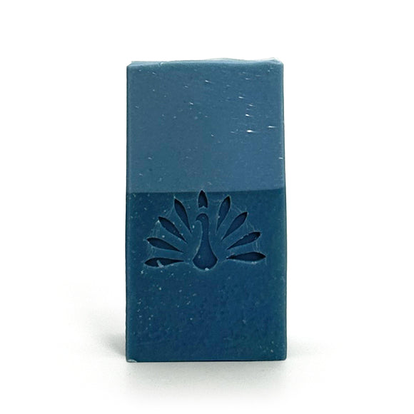 Two-toned blue bar of soap with the brand logo stamped on it.