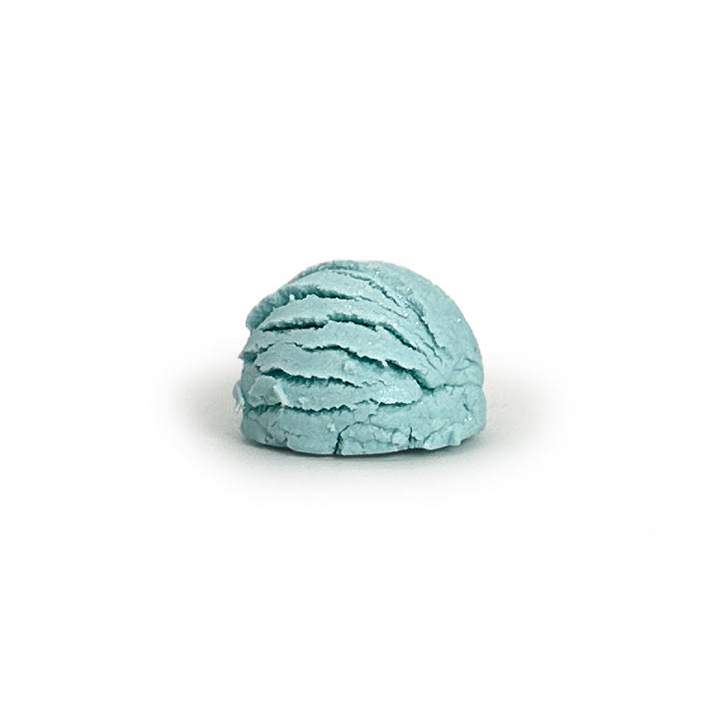 Light blue bubble bath truffle on a white background