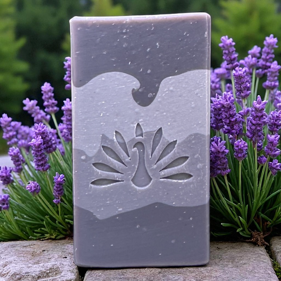 Violaine soap bar on a stone wall with lavender plants.