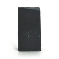 Black soap bar with a logo design on a white background