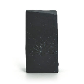 Black soap bar with a logo design on a white background