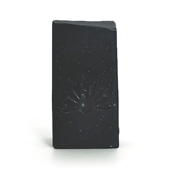 Black soap bar with a logo design on a white background