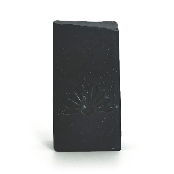 Black soap bar with a logo design on a white background