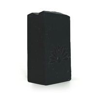 Black soap bar with a brand logo on a white background