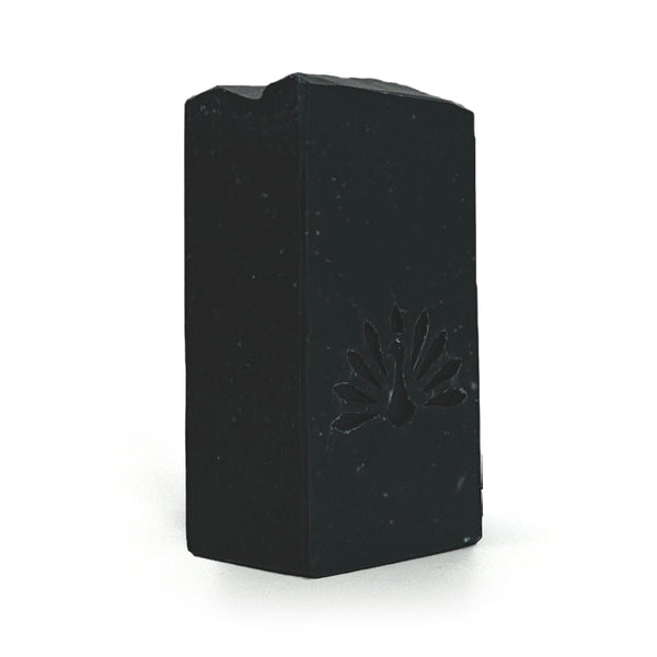 Black soap bar with a brand logo on a white background