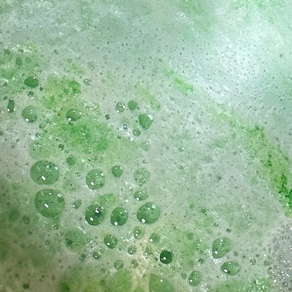 Close-up of green and white bath bomb foam texture