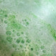 Close-up of green and white bath bomb foam texture