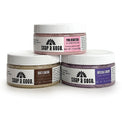 three jars of scrub on a white background
