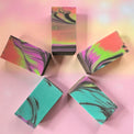 5 multi-colored soaps on a colorful background
