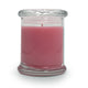 Pink candle in a clear glass jar on a white background