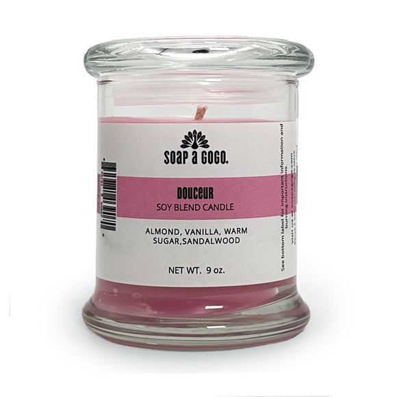 Candle in a glass jar with a label on a white background