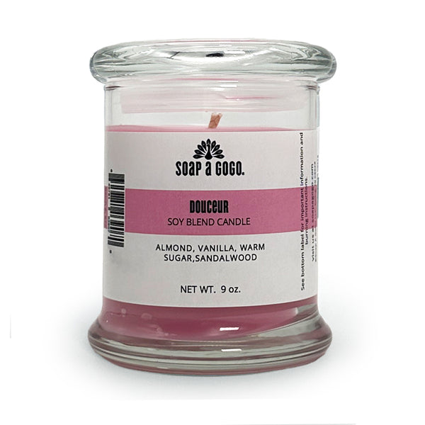 Candle in a glass jar with a label on a white background