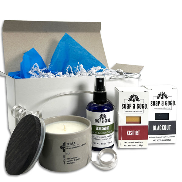 Gifting set with candle, spray bottle, and soap bars on a white background