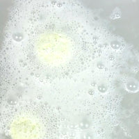 Foamy liquid with bubbles in a white container