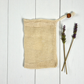 cotton soap saver pouch on a white wood background