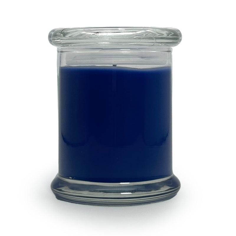 Blue candle in a clear glass jar on a white background