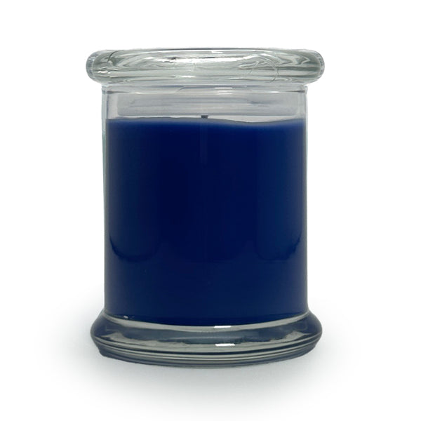 Blue candle in a clear glass jar on a white background