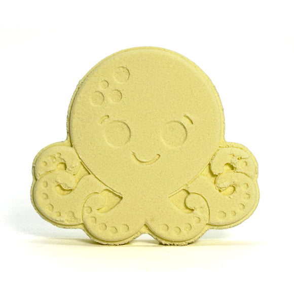 Yellow octopus-shaped bath bomb on a white background
