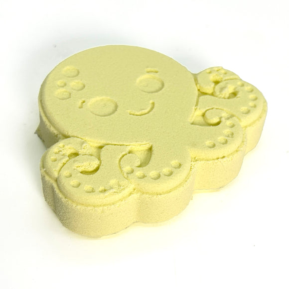 Yellow octopus-shaped bath bomb on a white background