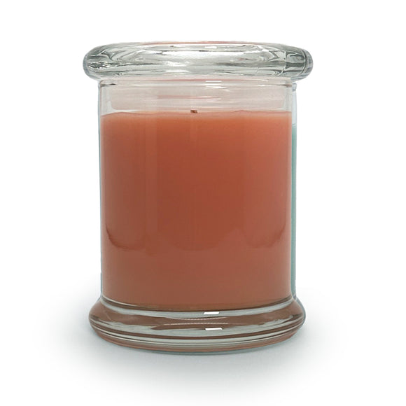 Candle in a clear glass jar on a white background