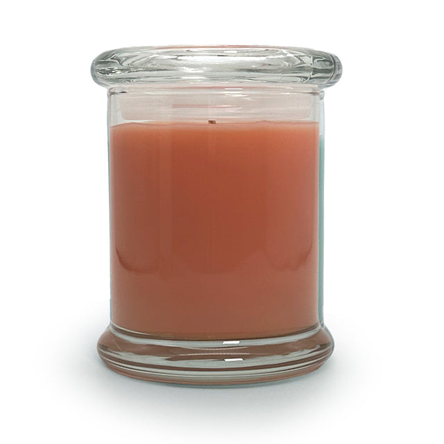 Candle in a clear glass jar on a white background