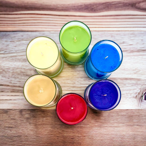 Colorful handmade candles in a circle on a wooden surface