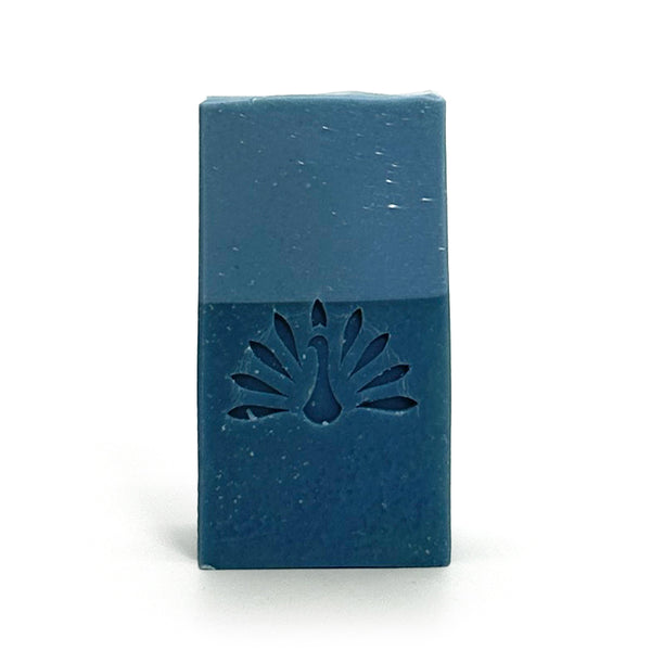 Two-toned blue bar of soap with the brand logo stamped on it.