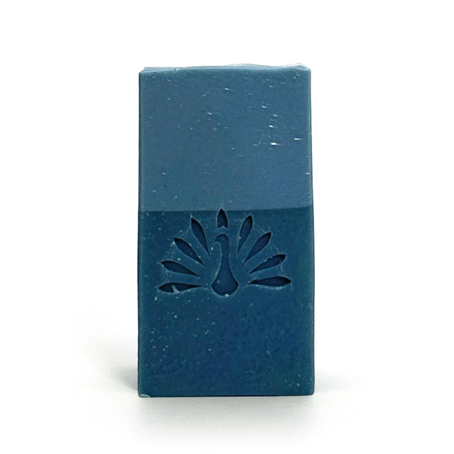 Two-toned blue bar of soap with the brand logo stamped on it.