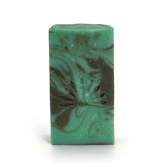 Green and gray swirled soap bar with with peacock logo on a white background