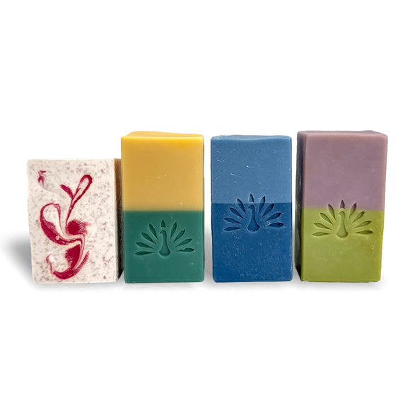 Four colorful soap bars with embossed logo on a white background
