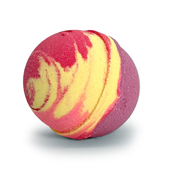 A spherical bath bomb with a marbled swirl pattern of magenta pink, yellow, and purple, photographed on a clean white background with a soft shadow.