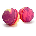 Two round bath bombs with a marbled swirl pattern of magenta pink, red, and pale yellow, shown on a clean white background.