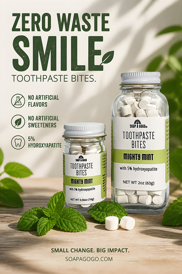 Two glass jars of Soap A GoGo Toothpaste Bites in Mighty Mint, displayed on a wooden surface with fresh mint leaves. The background features a warm, sun-dappled texture with green leaves, and the left side contains product feature icons and text.