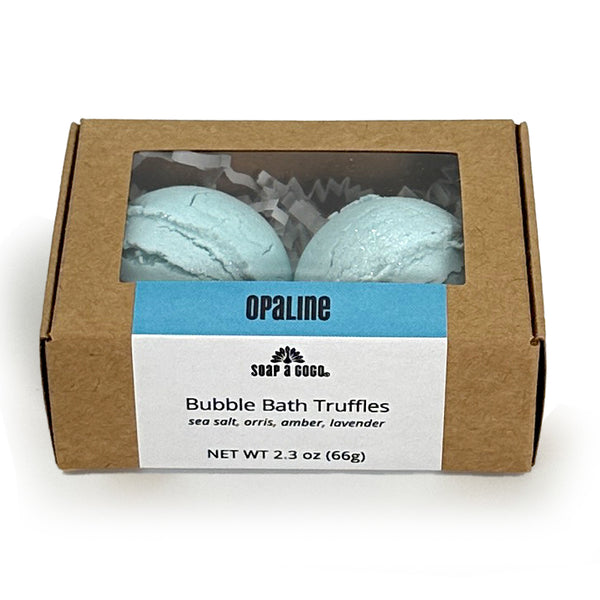 Box of Opaline Bubble Bath Truffles with two blue truffles inside on a white background