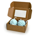 Two blue bubble bath truffles in a cardboard box on a white background