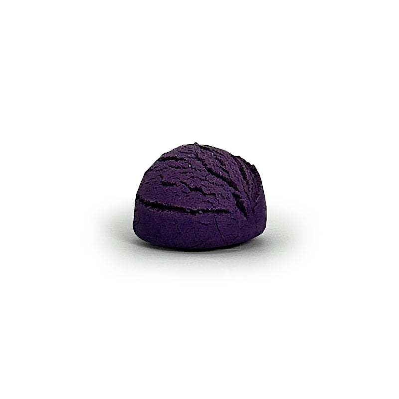 Purple bubble bath truffle on a white background
