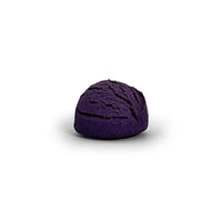 Purple bubble bath truffle on a white background