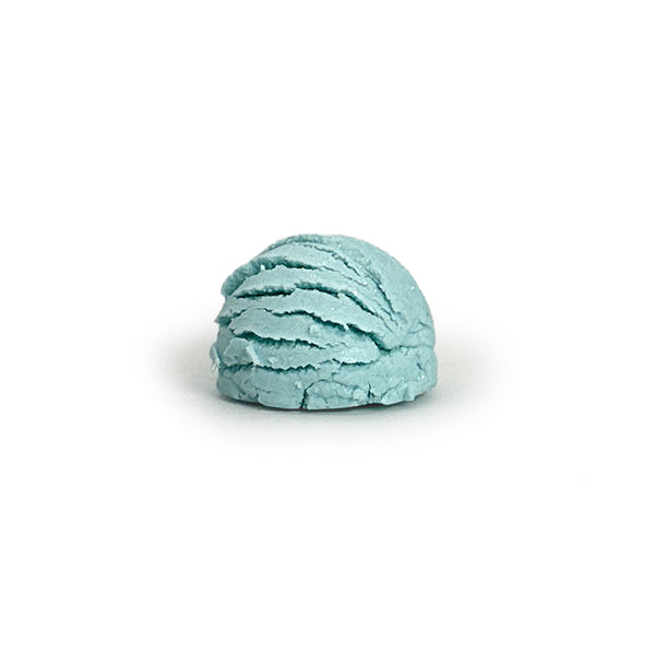 Light blue bubble bath truffle on a white background
