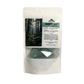 Product packaging with a forest scene and product details on a white background
