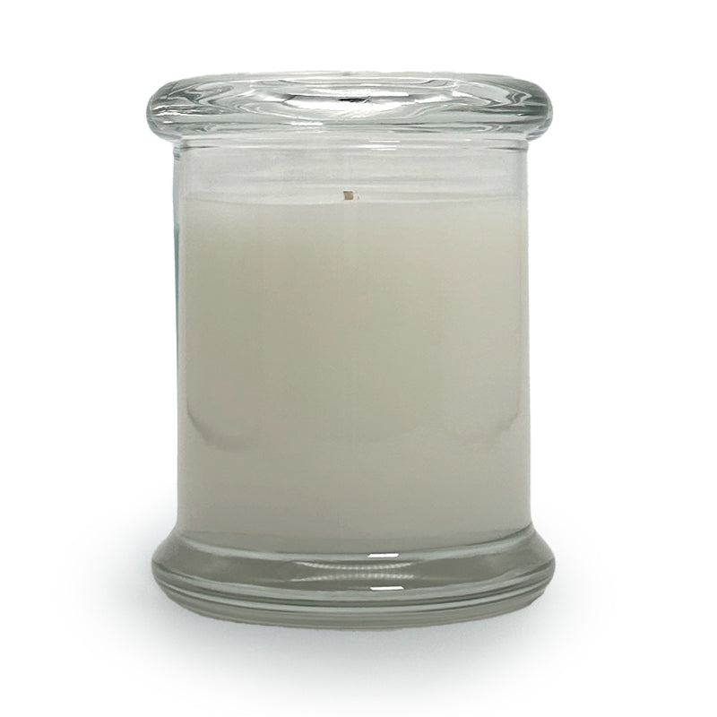 Soy blend candle in a clear glass jar with glass top