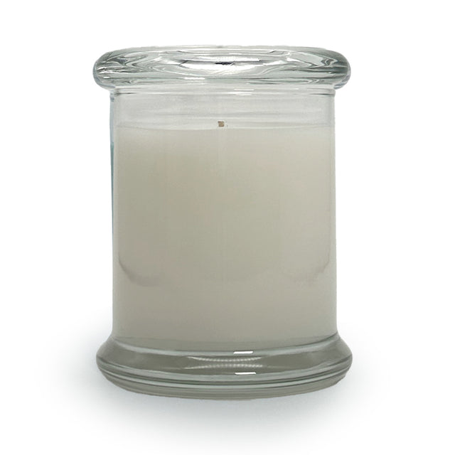 Soy blend candle in a clear glass jar with glass top